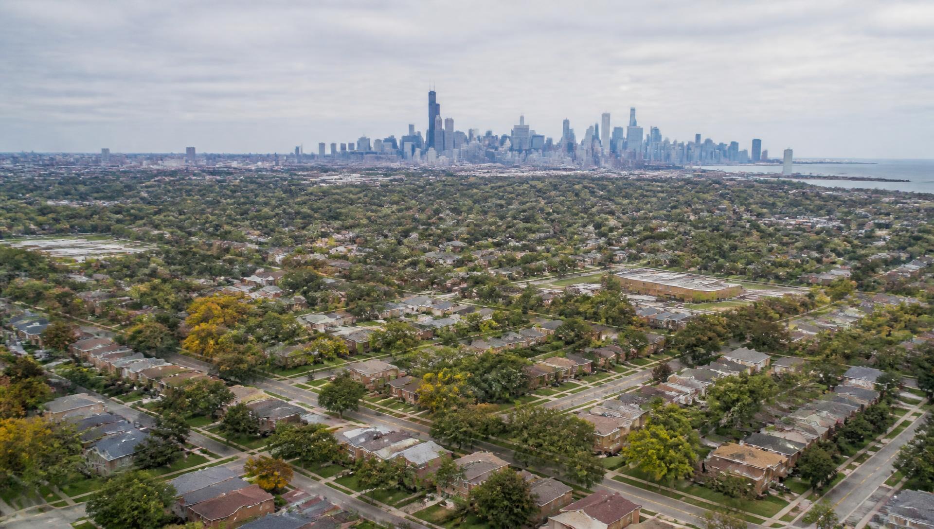 Aerial view of Chicagoland residential neighborhoods with the Chicago skyline in the distance